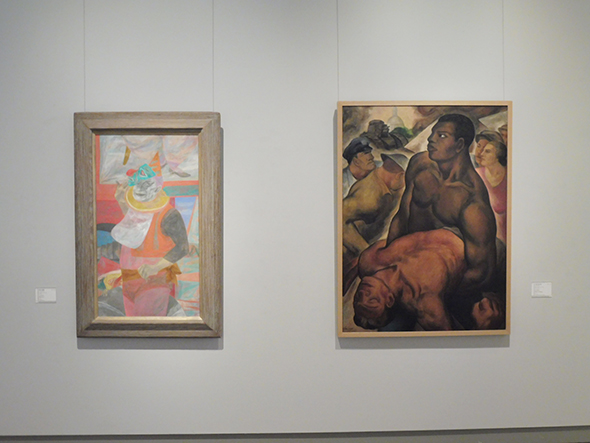 左：国吉康雄《ミスターエース》1952（昭和27）年　福武コレクション　右：石垣栄太郎《ボーナス・マーチ》1932（昭和7）年　和歌山県立近代美術館蔵　本展の冒頭を飾る展示で、２人の作風の違いがよく分かる