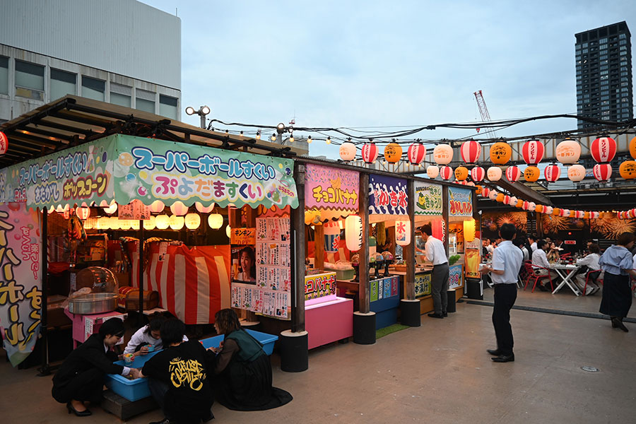 『祭屋台とBBQビアガーデン 屋上祭宴』の様子。大人たちがスーパーボウルすくいに夢中に