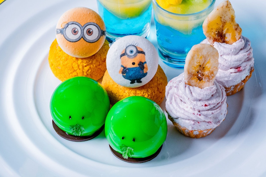 grandprinceosakabayminions_202607_2 | Lmaga.jp スイーツ4種類。写真右上から時計回りに、トロピカルフルーツゼリー、バナナタルトのストロベリーモンブラン仕立て、グーミーのピスタチオムース、ミニオンマカロンシュークリーム